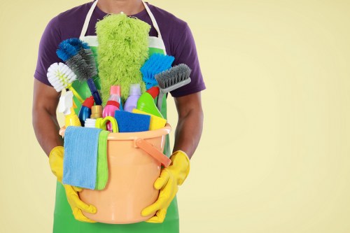 Carpet cleaning technician preparing equipment with safety measures in place